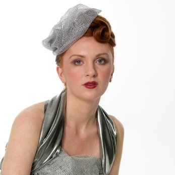 a netted tam hat pinned to one side emulates a typical 1940 39s hairstyle